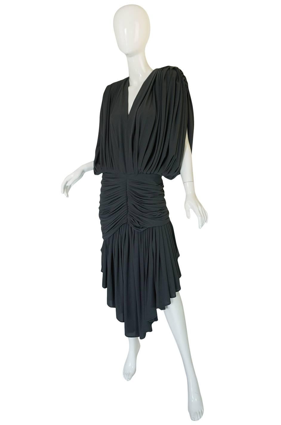This spectacular eighties dress with its matching shawl from Norma Kamali is not only super sexy but it gives you lots of styling options and is instantly recognizable as from her. It is made from her signature slinky, lightweight jersey that she