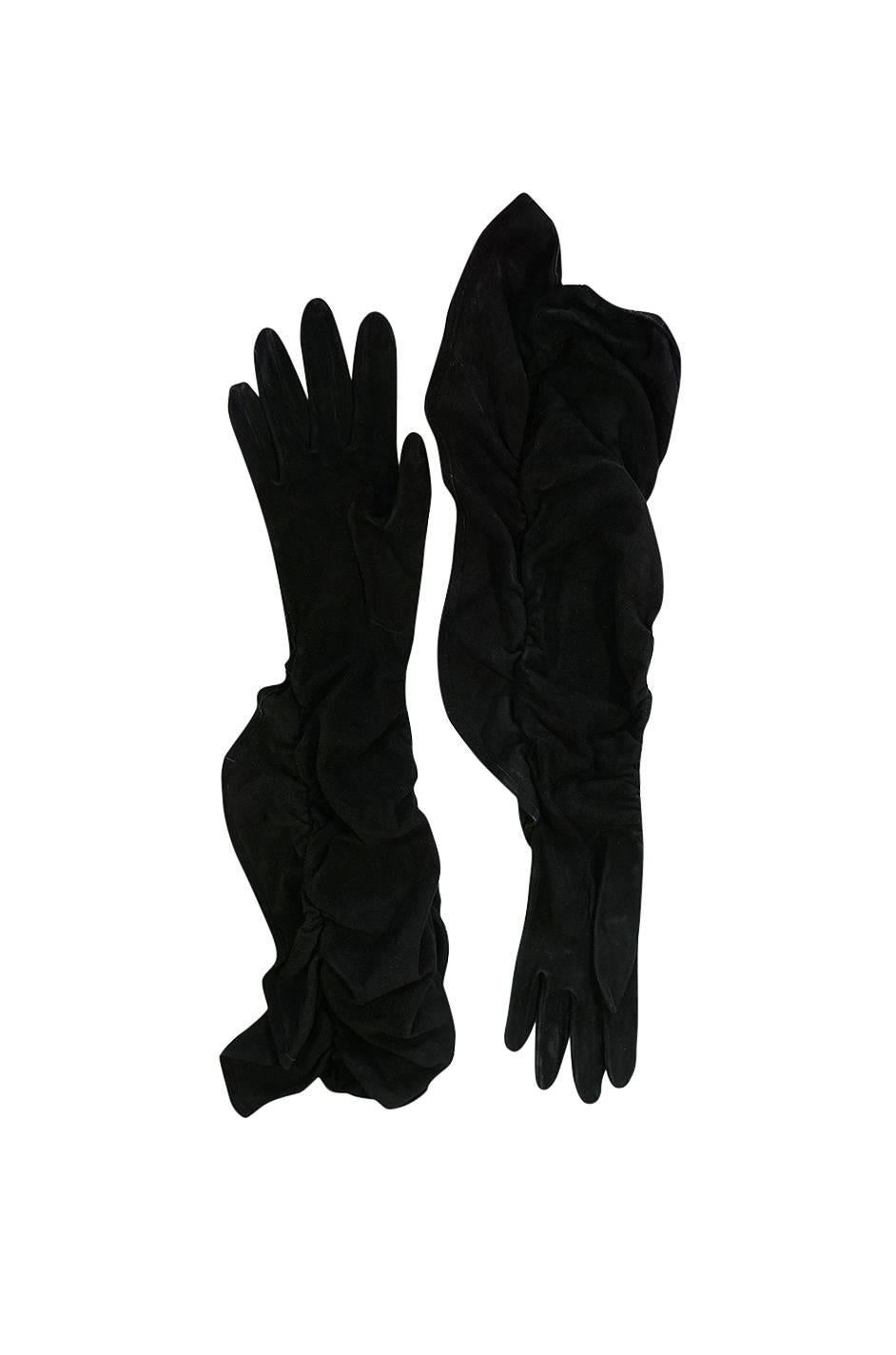 

Wonderful vintage Hermes gloves that are made from the finest, lightest black suede. Each is full opera length so you can wear them high up on the arm well past the elbow or scrunch them down. They are unlined which allows them to perfectly mold
