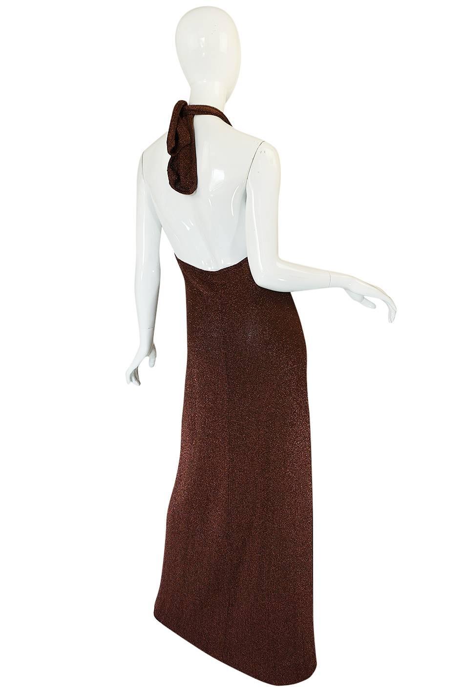 

The Museum at FIT holds the black version of this 1973 dress and while you can never go wrong with a black dress I think this copper twin of that one pops just a little more. Like all Halston pieces the design is as simple as he could possibly