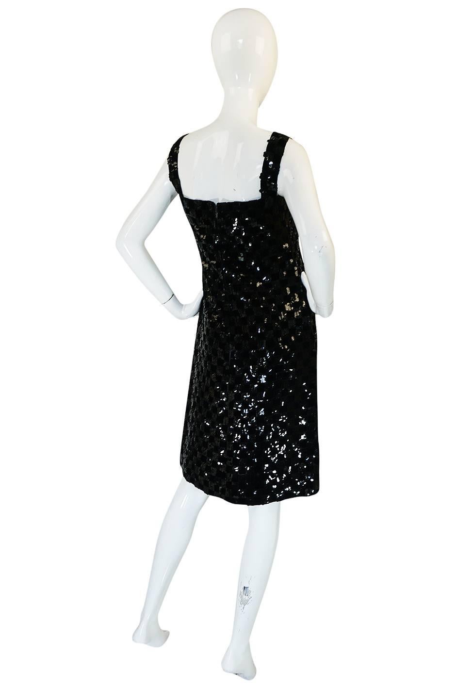 

This Malcolm Starr is just terrific and a glamorous take on the little black dress. That fabulous checked pattern is made by the application of little squares of glossy black sequins in a silk organza based with black velvet velvet squares fused