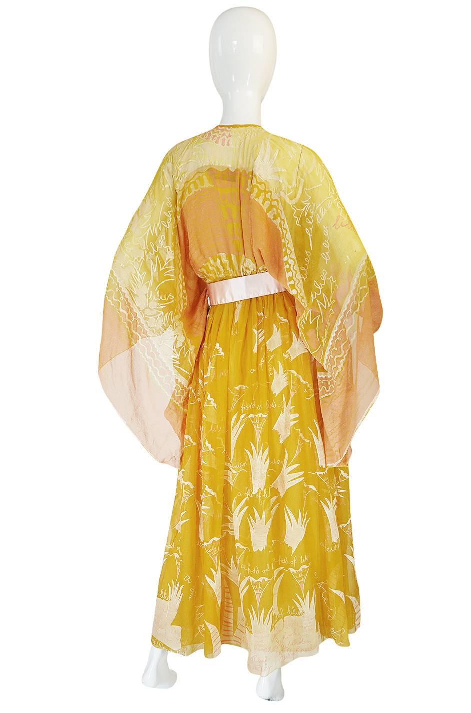 This rare and amazing, entirely hand painted, silk caftan gown is just wonderful. This version is a beautiful and extremely rare combination of a peach, a deep goldenrod yellow and pinks, with a pale pink blush belt. I have never actually seen this