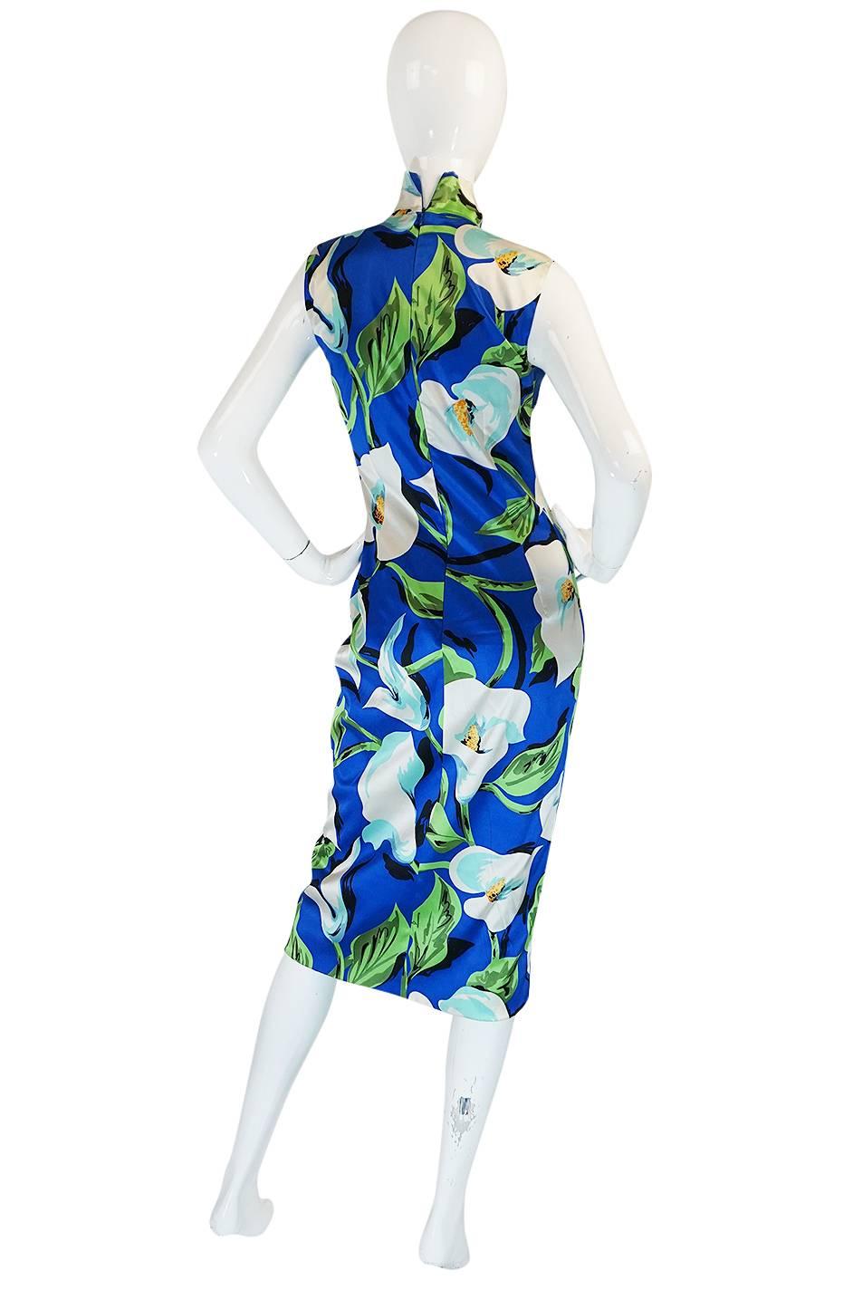 

A seriously sexy and very form fitting Dolce & Gabbana dress that is made of a bright, tropical feeling floral printed stretch silk that is made to mold and hug the body. You just step in, zip it and it instantly clings to every curve. I love