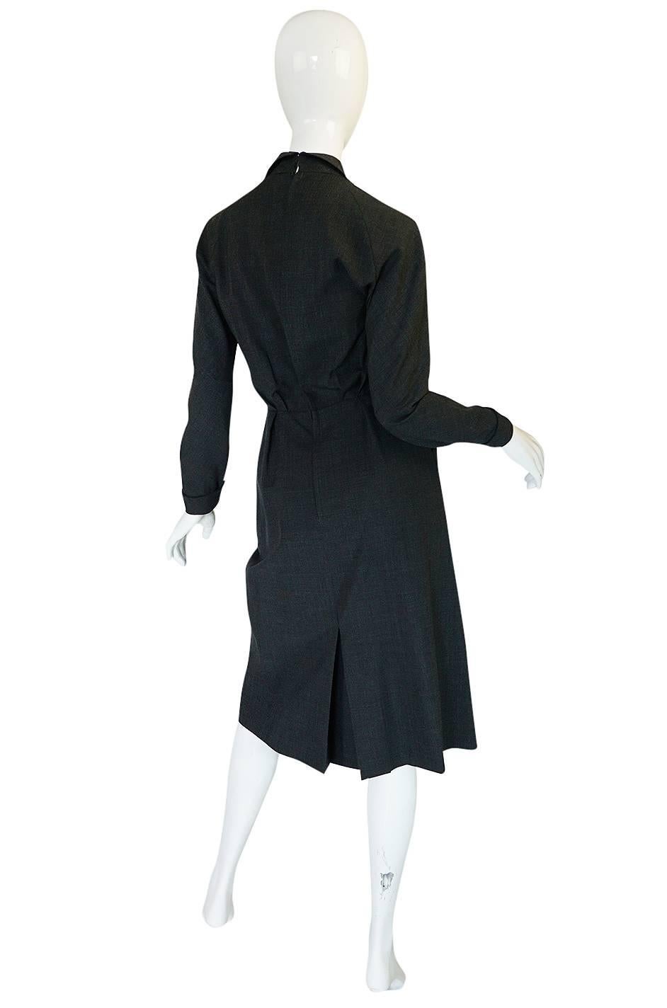 This wonderful tailored and chic dress is labeled Christian Dior Original and pieces form this time period with this label were almost always a custom or special order. This would have been based on the Dior Haute Couture collection designed by