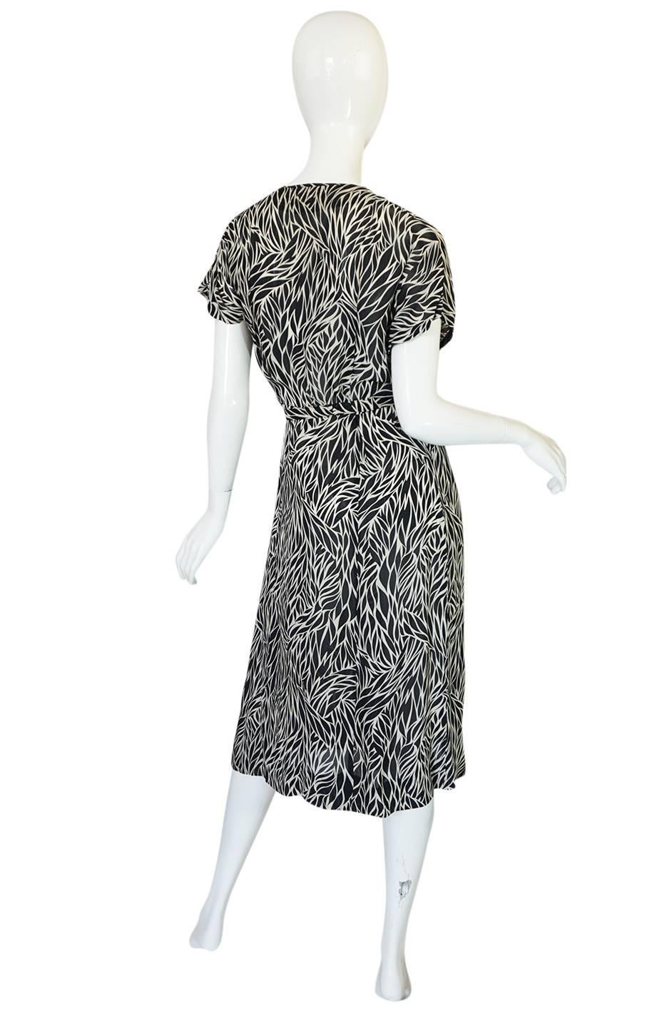 This wonderful little dress is so light and easy to wear. It just slips over the head, falls into place and you belt it at the waist for shape. The fabric is a pretty silk chiffon with a graphic black and white print over its surface. The bodice is