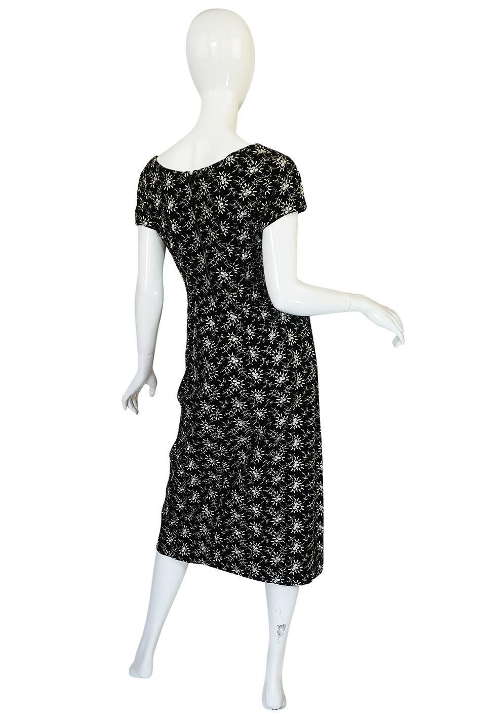 This is really an amazing and strong styled late forties dress that I just love. It is made of a black cotton velvet so has mote of a matte feel and flatness to the pile then its silk counterparts. Over this it has an amazing hand embroidered design
