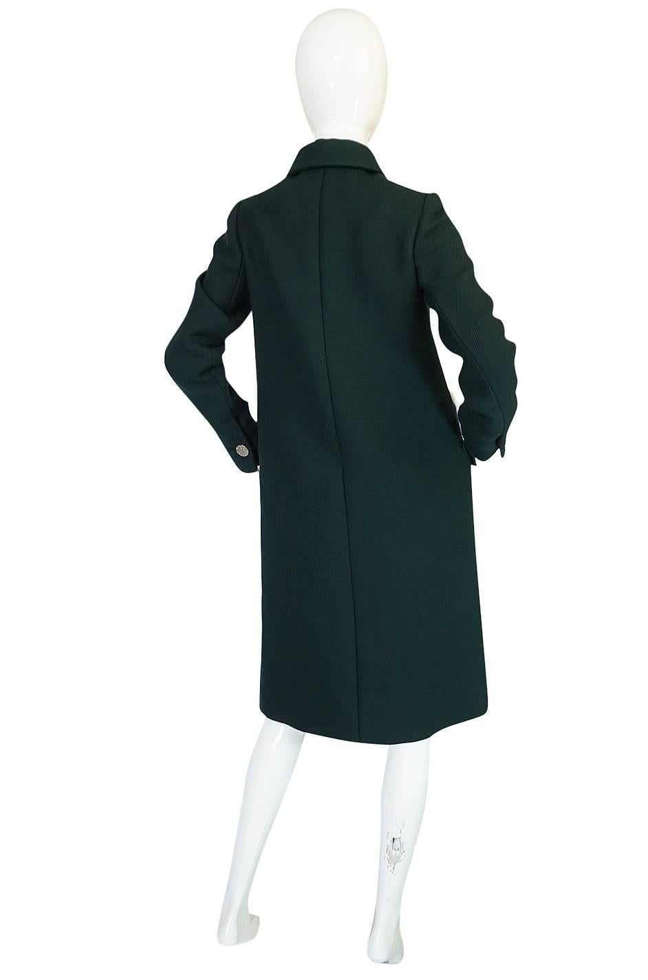 The color is the first thing that catches your eye. In a sea fo black vintage coats this deep green hue is a refreshing change. The double row of textured silver buttons that run down the coat and give it that fantastic military feel are the next
