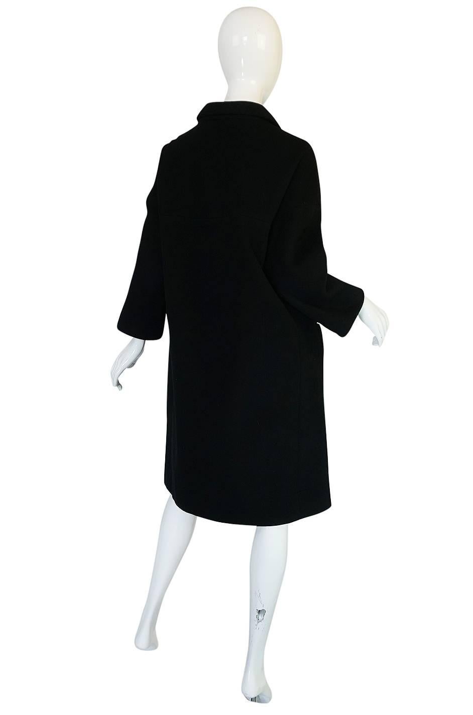 This coat is extraordinary. It dates to approx the 1962-63 Haute Couture collection and is impeccable. A similar coat is held in The Metropolitan Museum permanent archives (reference photo to the left). Cristobal Balenciaga was known for his fine