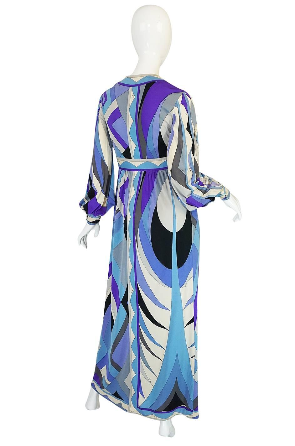 An absolutely gorgeous Pucci dress with a sublime and chic color palette in soft blues and lavenders mixed with greys and off-white. It is made from his signature lightweight silk jersey and has one of his signature custom screened designs running
