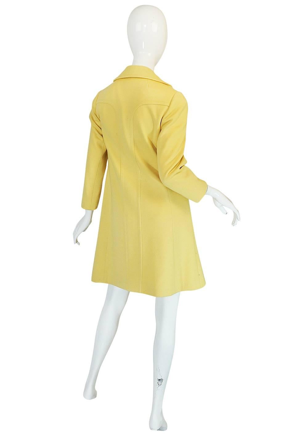 

What a gorgeous little coat that is so representative of the sixties. The fabric is just wonderful - it is a soft, pale yellow knit wool jersey that has enough weight to give it structure and hold the lines but without feeling too heavy when on.