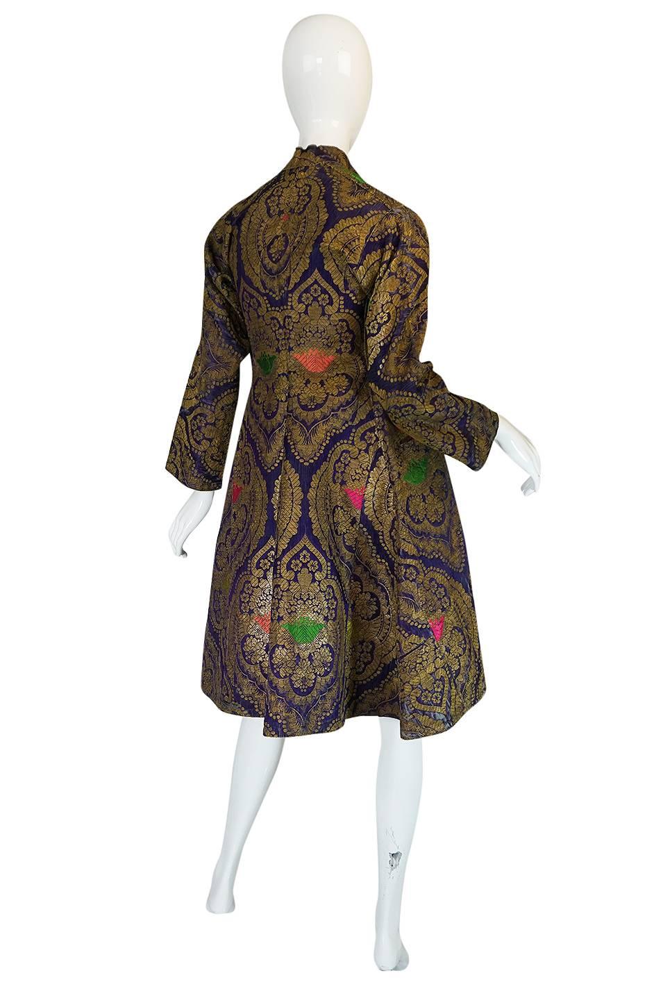 

This is one of the most beautiful antique coats I have ever had in the shop. It is made from a beautiful Russian metallic brocade with a bright contrasting cotton lining. Both fabrics inside and out are extraordinary. The exterior fabric is a real
