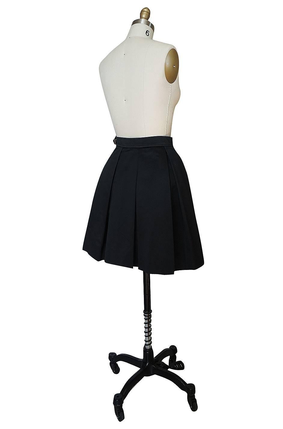I love this fabulous little pleated mini skirt by Yves Saint Laurent with its schoolgirl feel. It is made of a crisp cotton and a basic black so it can be worn endlessly. The waist cinches in and below that the skirt has a fabulous fullness to it.
