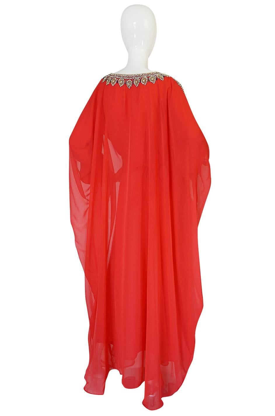 This is an absolutely incredible caftan that appears to have been custom or hand made. The detailing and embellishment that has been added to this caftan is remarkable. It has a decent weight to it - the red chiffon fabric is very light in weight