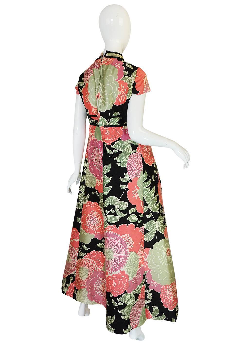 This beautiful and spring-time feeling dress is one of my favorites from the pieces of Malcolm Starr that I have had in the shop. The silk fabric is very pretty and fresh feeling with huge flowers splayed across its surface. The bodice skims over