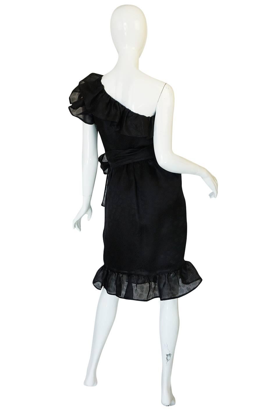 This little black dress is a beauty. It is just exceptional and the more details you start to notice the more you love it. The design is a one shoulder, fitted silhouette that is all tiered ruffles that highlight that design. The bodice is fitted to