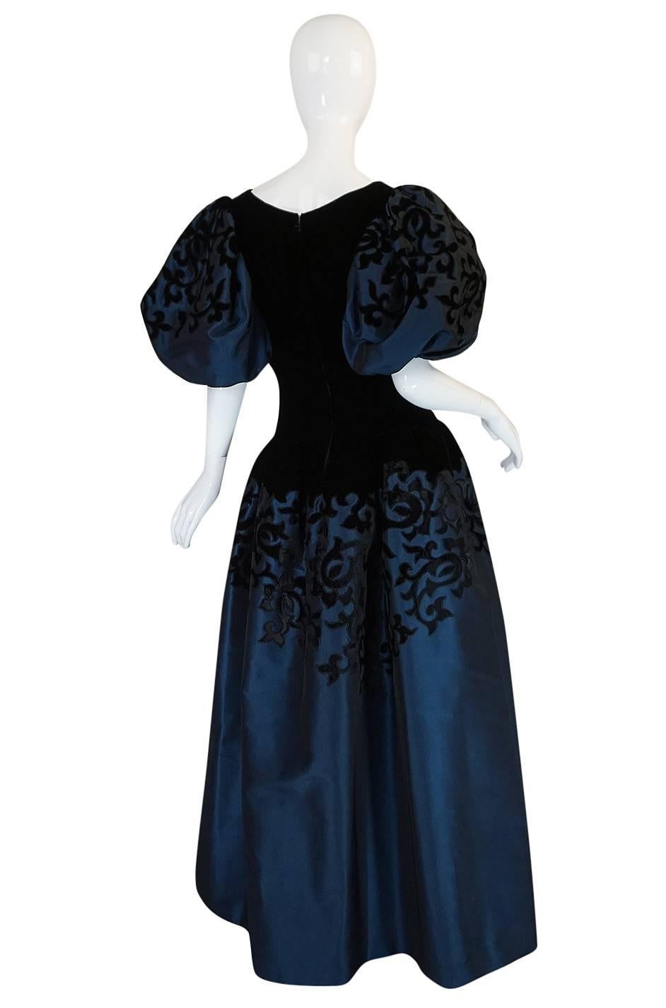 This beautiful and regal feeling gown by Oscar de la Renta is even better in real life. That classic combination of a deep, rich blue silk taffeta with the black velvet applique and bodice is spectacular. It is also cut in a beautiful sculpted way