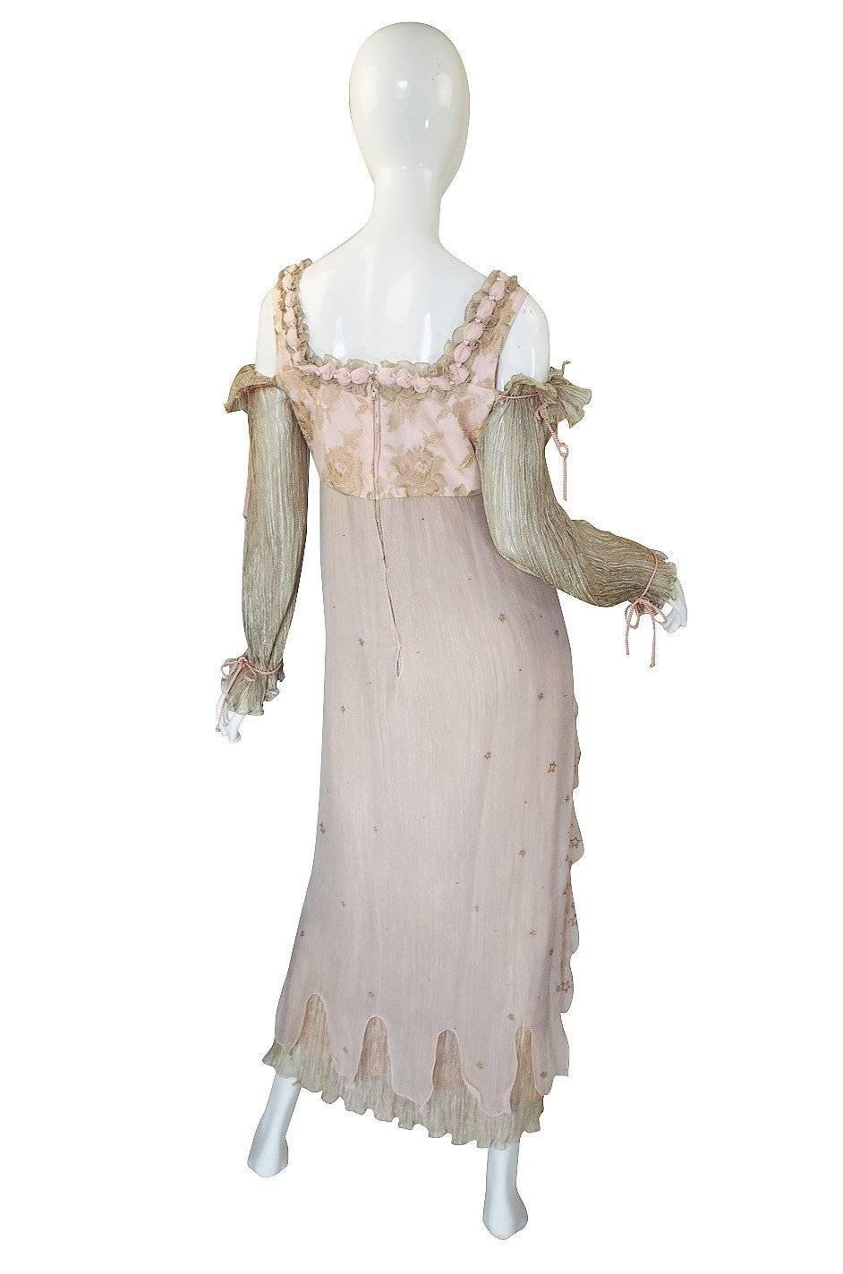 A stunning, hand painted gown from Zandra Rhodes that was most likely a custom order and it is not a far stretch of the imagination to think that it could have been used as a wedding gown even! It has a delicious Medieval feel to it with its cut out