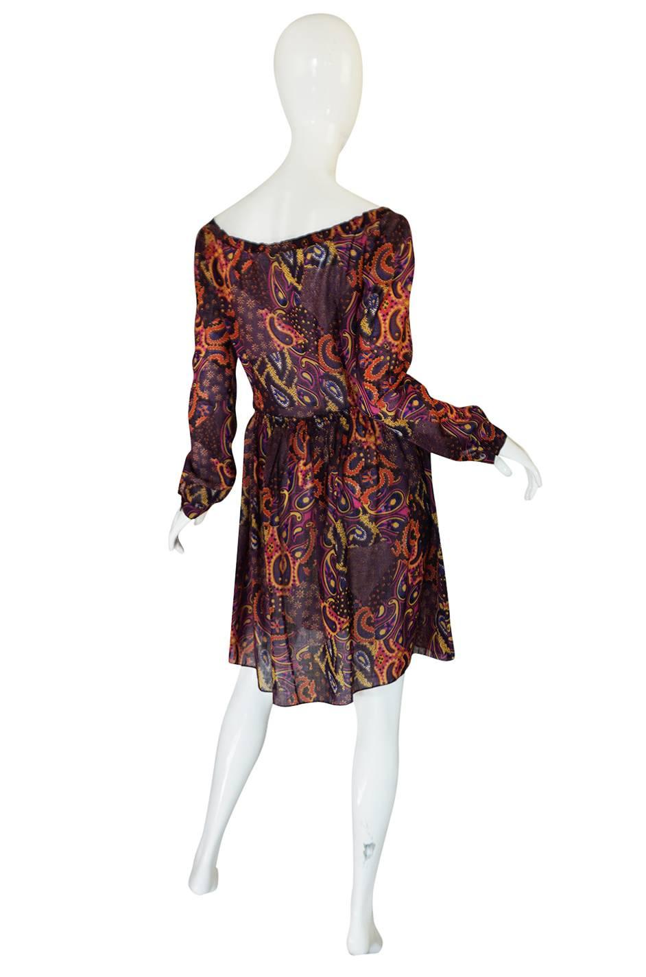 This dress is so pretty and easy to wear. The print is an elaborate and intricate paisley in swirls of color with the base color being purple. The fabric is a semi-sheer cotton voile with makes it so light and easy to wear. The cut is also easy with