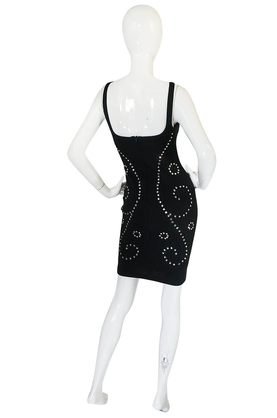 Looking like it just came straight from the 1990s catwalk comes this iconic rhinestone encrusted dress by New York design phenomenon Todd Oldham. It is a super sexy little black knit number that fits and hugs your every curve. it is made of a