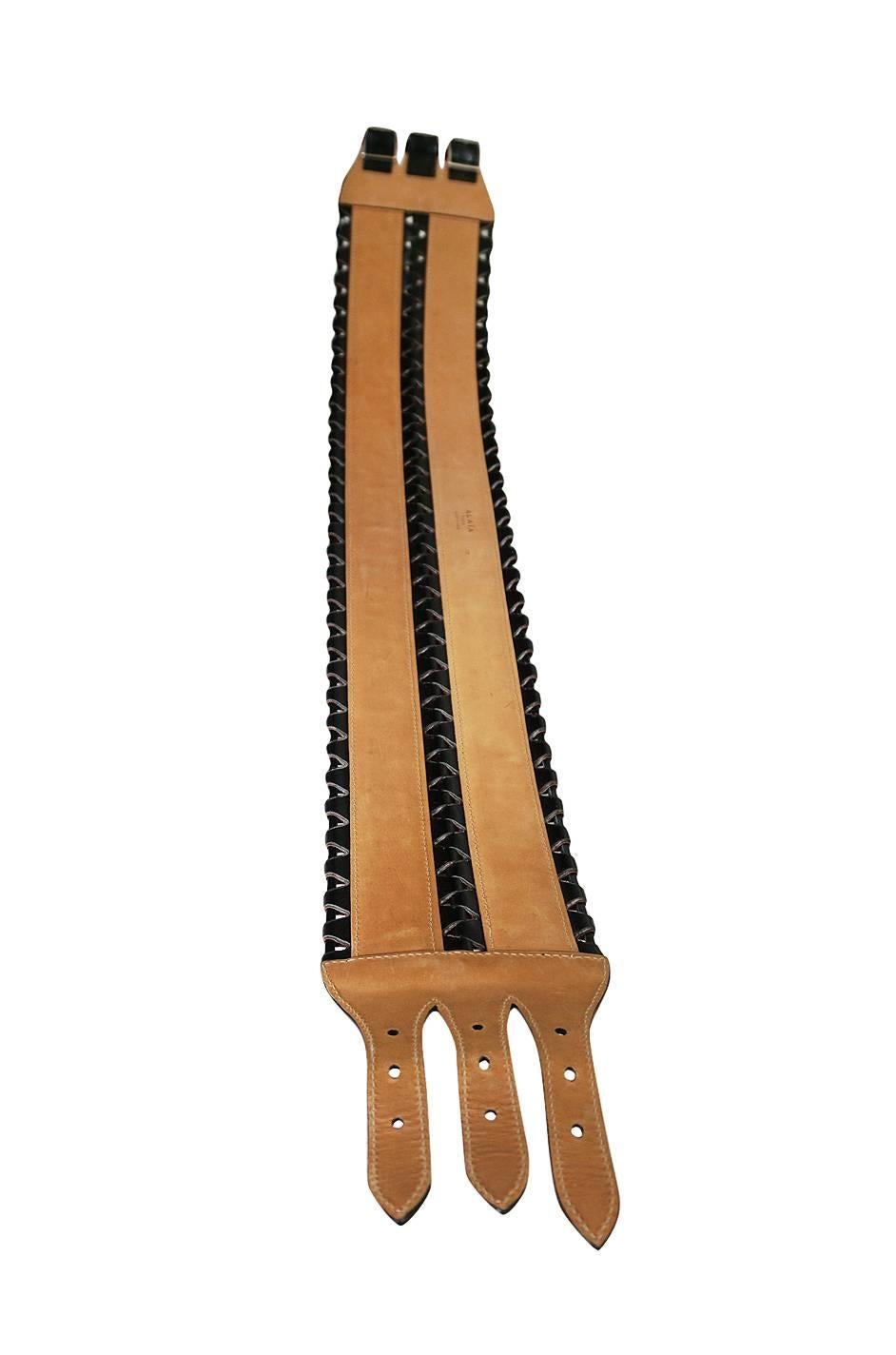 The wide Alaia corset belt in butter soft black leather is a closet staple for any woman who loves fashion. Nothing gives you that hour glass figure like buckling on over whatever you are wearing. Its an instant statement piece. This recent example