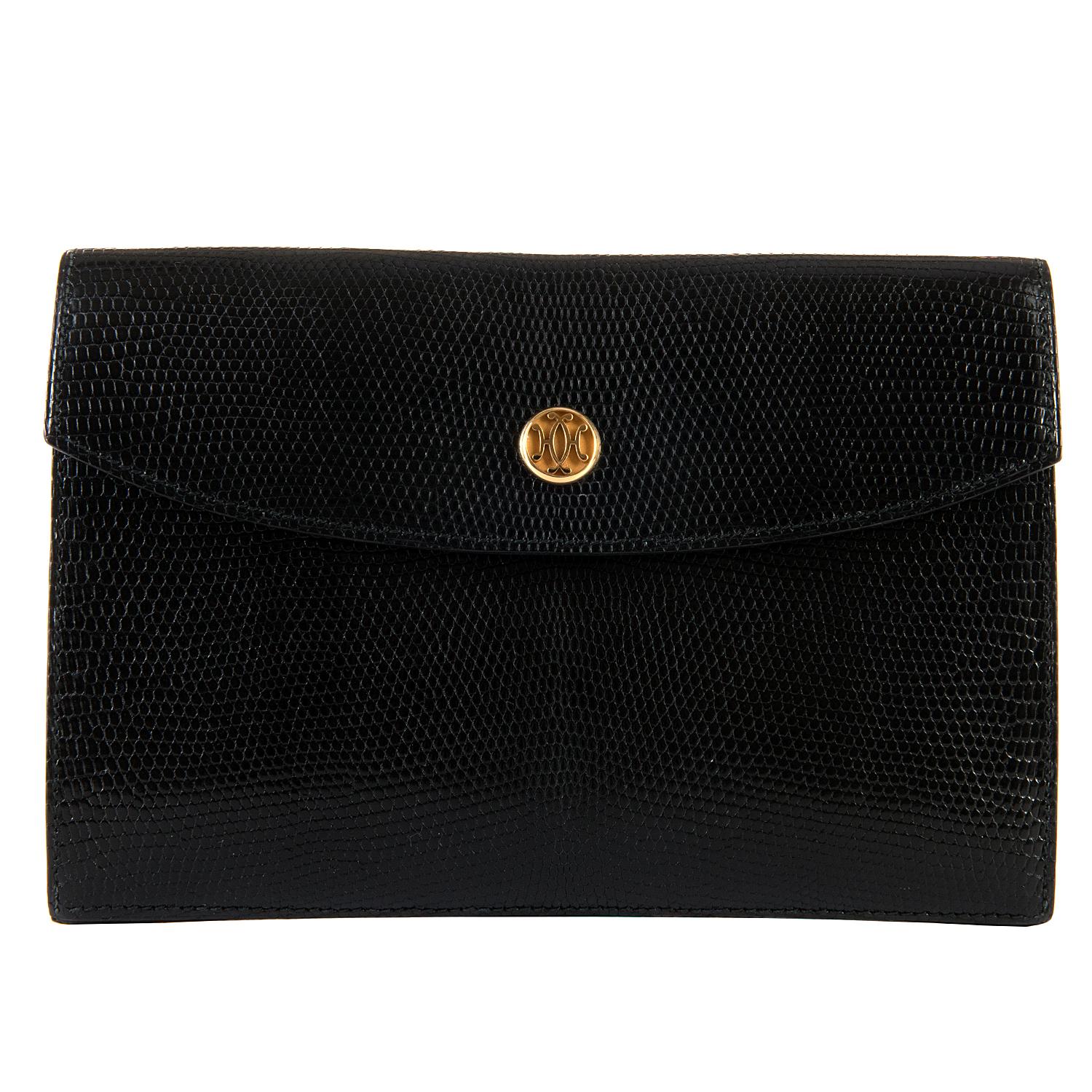 This Very Rare Vintage Hermes Black Lizard Clutch Bag is in pristine condition and is beautifully finished with an 18ct. plated gold clasp embossed with the makers famous  double 'H' logo. Still with its original Hermes dust sack. 