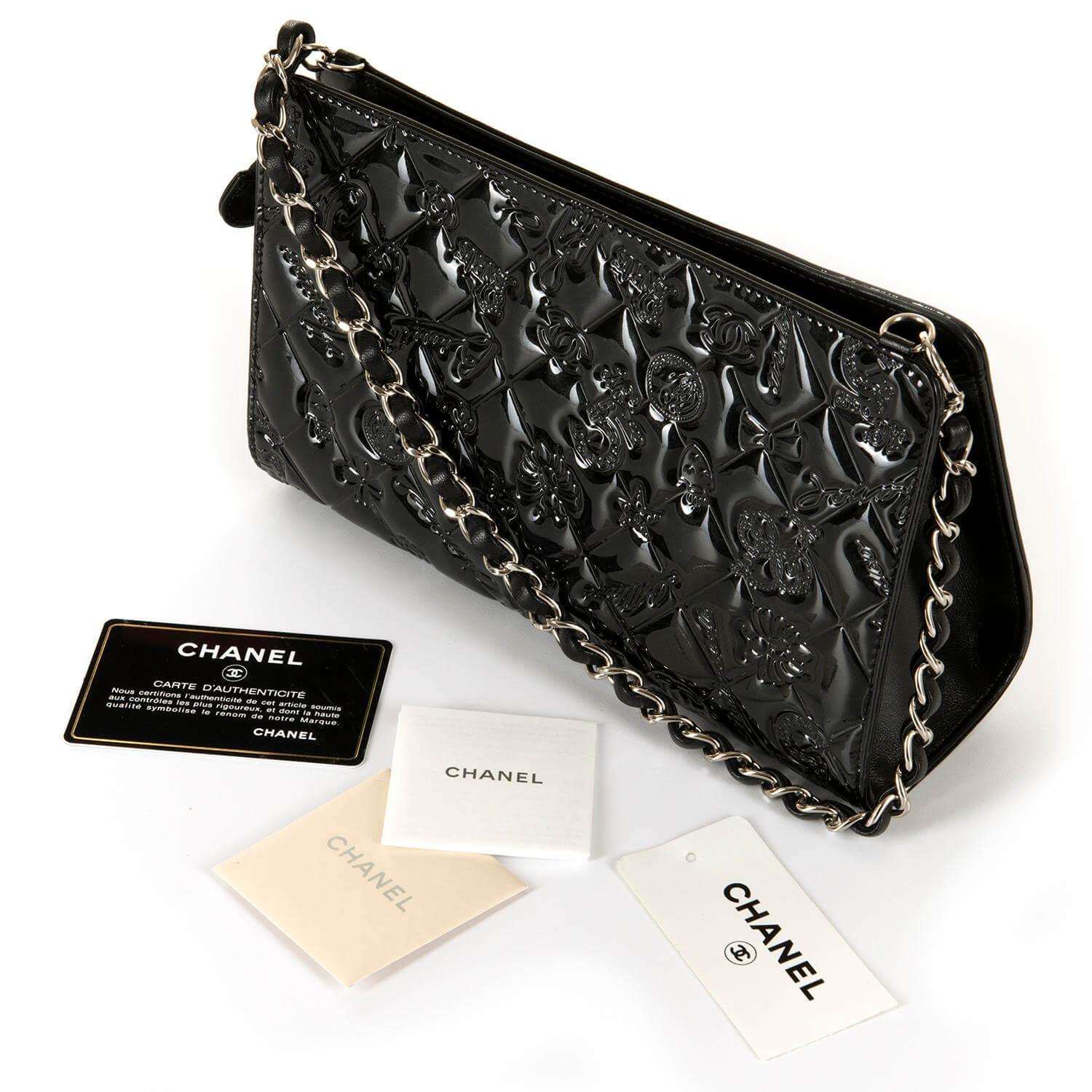 A Very Chic Chanel Black 'Lucky Charms' Embossed, Patent Leather Evening Bag with Silver Hardware. In pristine condition, this rare bag has never been worn and comes with it's Chanel authenticity card, care card & original Tag. The unique Chanel