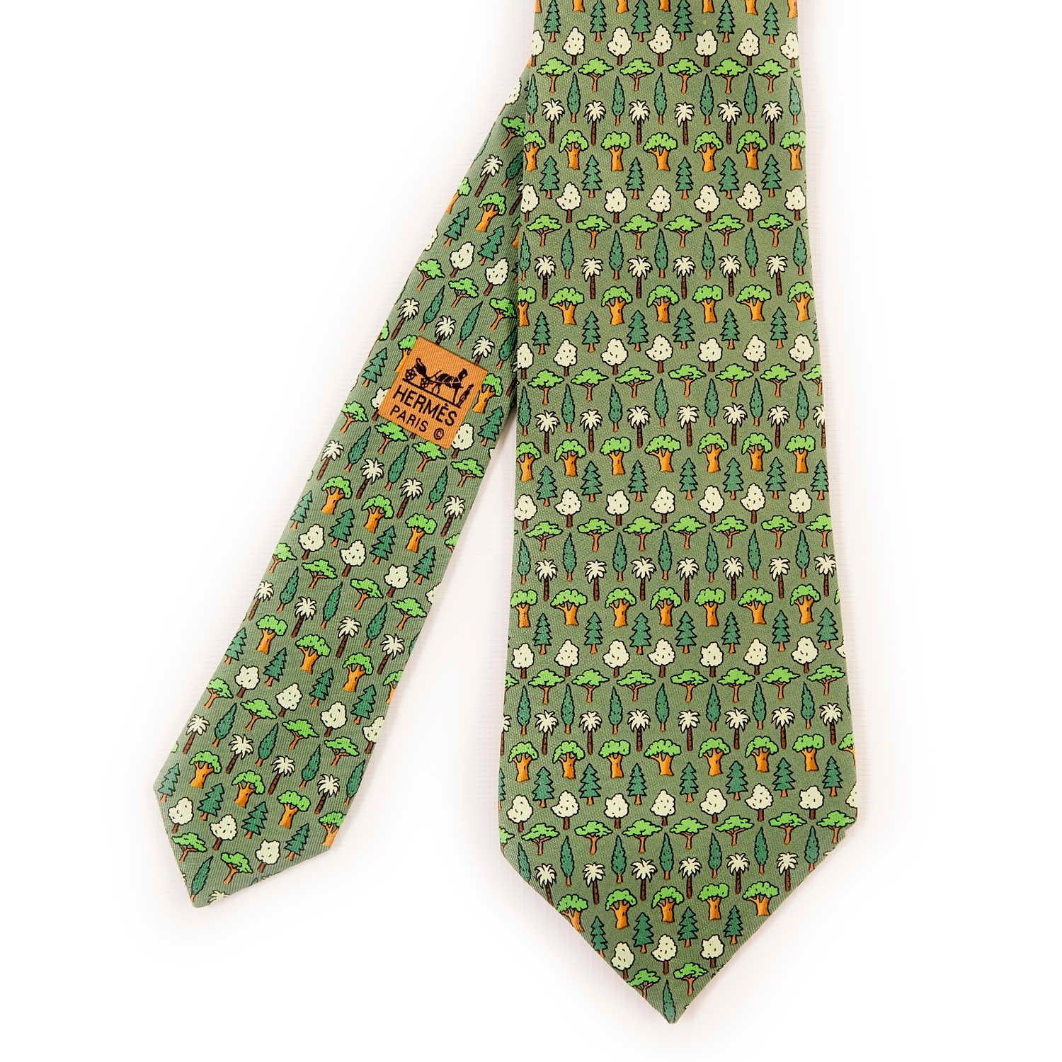 A delightful Hermes Vintage Silk Tie 'Evergreen' features whimsical designs of Evergreen trees. The Tie is on an apple green ground.