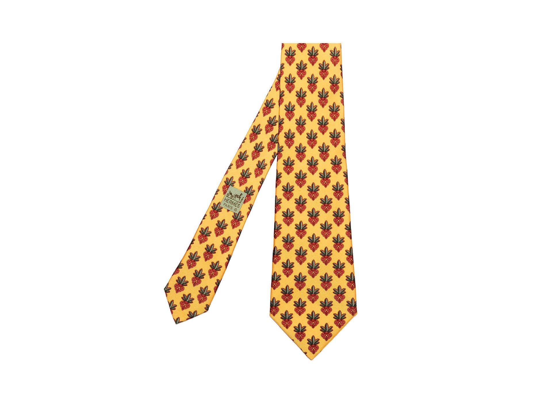 With scrolled decoration on a yellow ground, this superb Hermes vintage silk tie is in pristine condition.