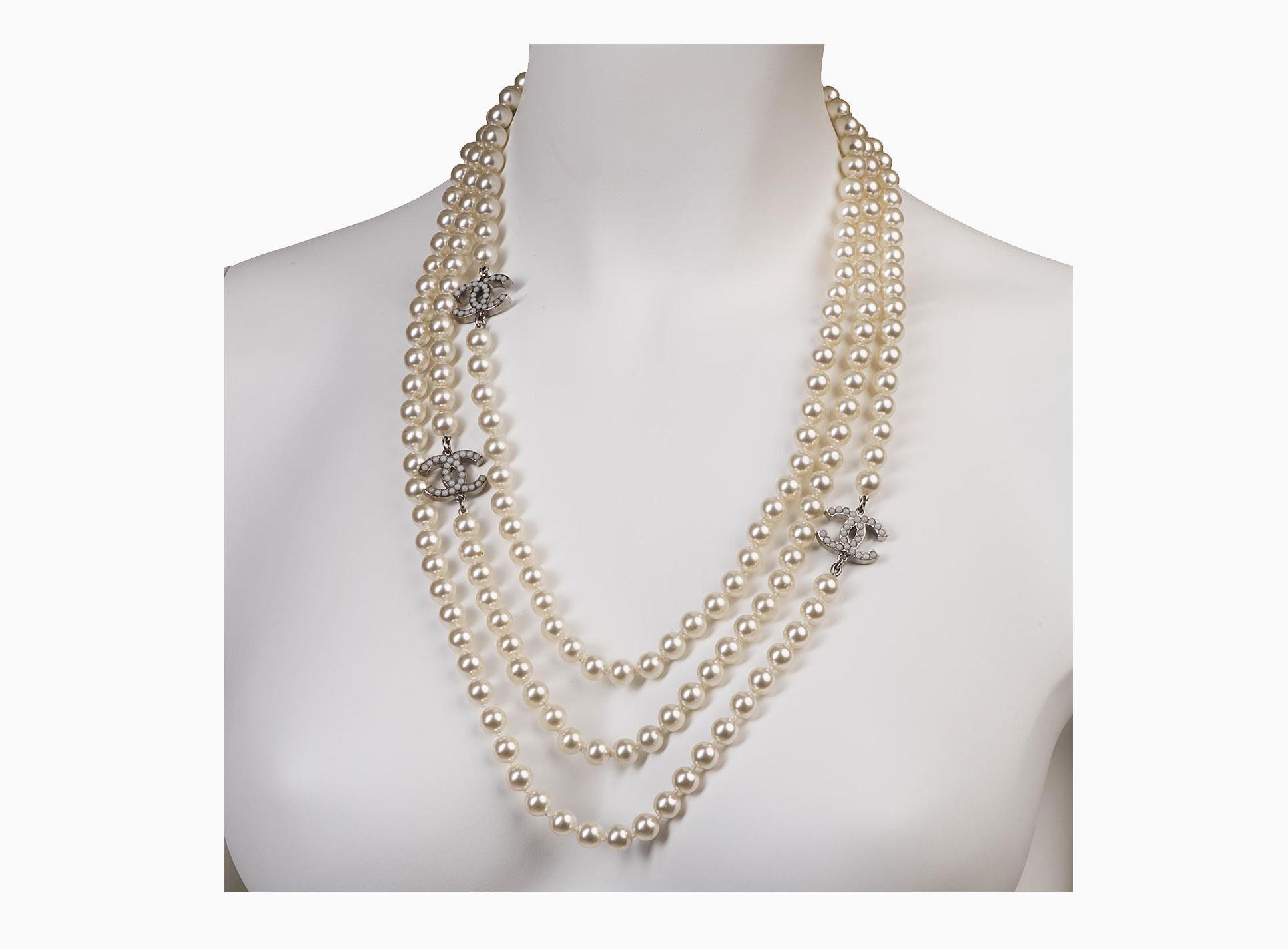 Pure Luxury !! This Chanel 3-String Necklace, decorated with three interlocking CC's, each inset with faux pearls in a white metal border. In absolutely pristine condition, this beautiful piece is 'Store-Fresh and comes with it's original gift box &