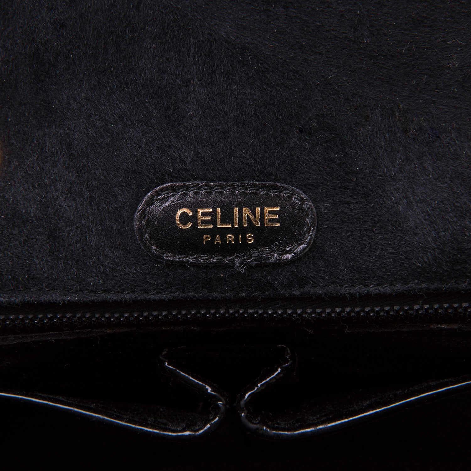 This classic beautiful vintage shoulder bag by Celine of Paris, is finished in black calf-suede with gold-tone hardware. Of superb quality, the double chain-link handles are complemented by Celine's iconic latch-clasp. In superb condition, inside