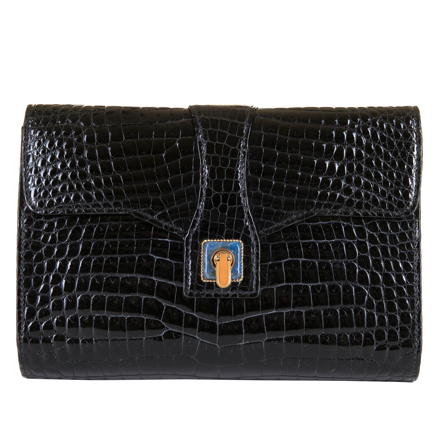 In pristine condition, this Gucci Black Crocodile 22cm Clutch is the epitome of luxury & style. Made in circa 1980, the gold clasp is embellished with semi-precious lapis Lazuli. This high quality bag has a timeless quality that will become a real