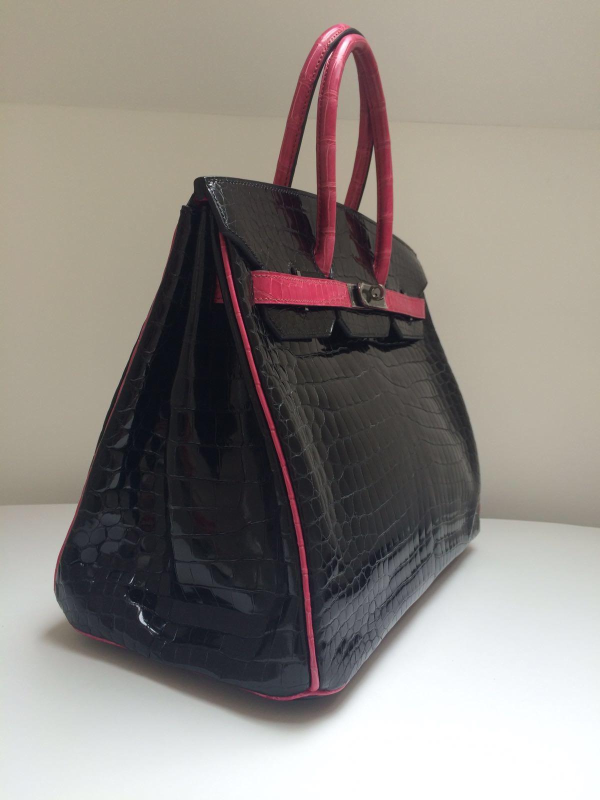 This beautiful 35cm Birkin is one from a series made 10 years or so ago in Black Shiny Porosus Crocodile and Ruthenium hardware with piping, straps and the handle in one of their bright standout colours – on this occasion Fuchsia.  Ruthenium is a