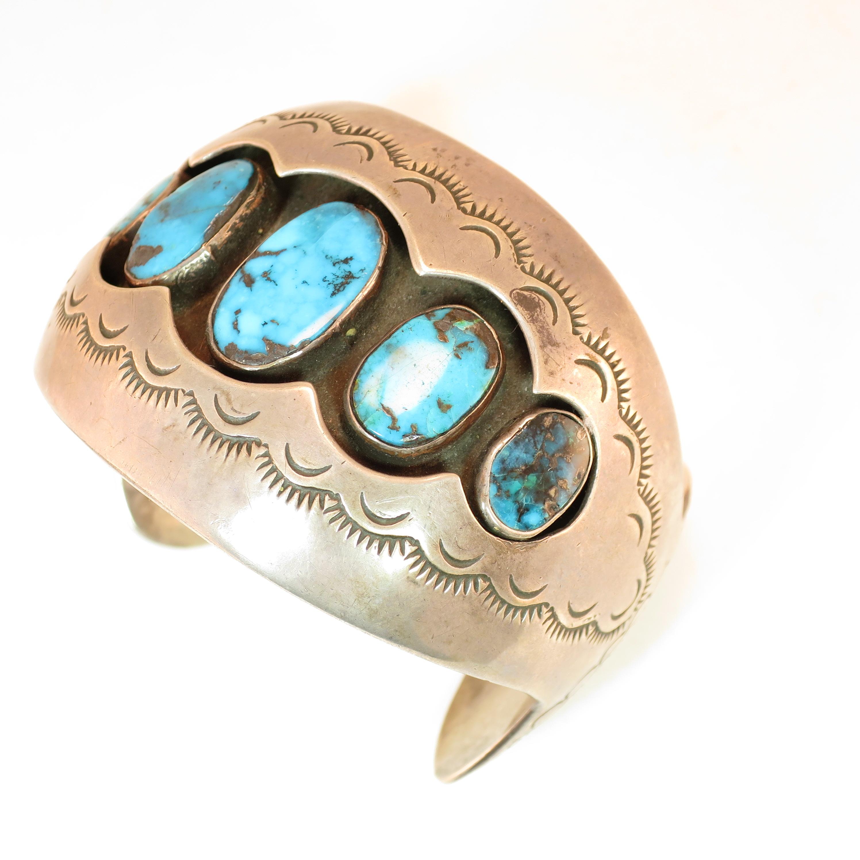 Offered here is a Native American Zuni sterling silver and turquoise cuff bracelet crafted by Mabel Watson in the 1970s. This oversize cuff offers a deep shadowbox design presenting five graduated bezel-set oval turquoise stones with black and