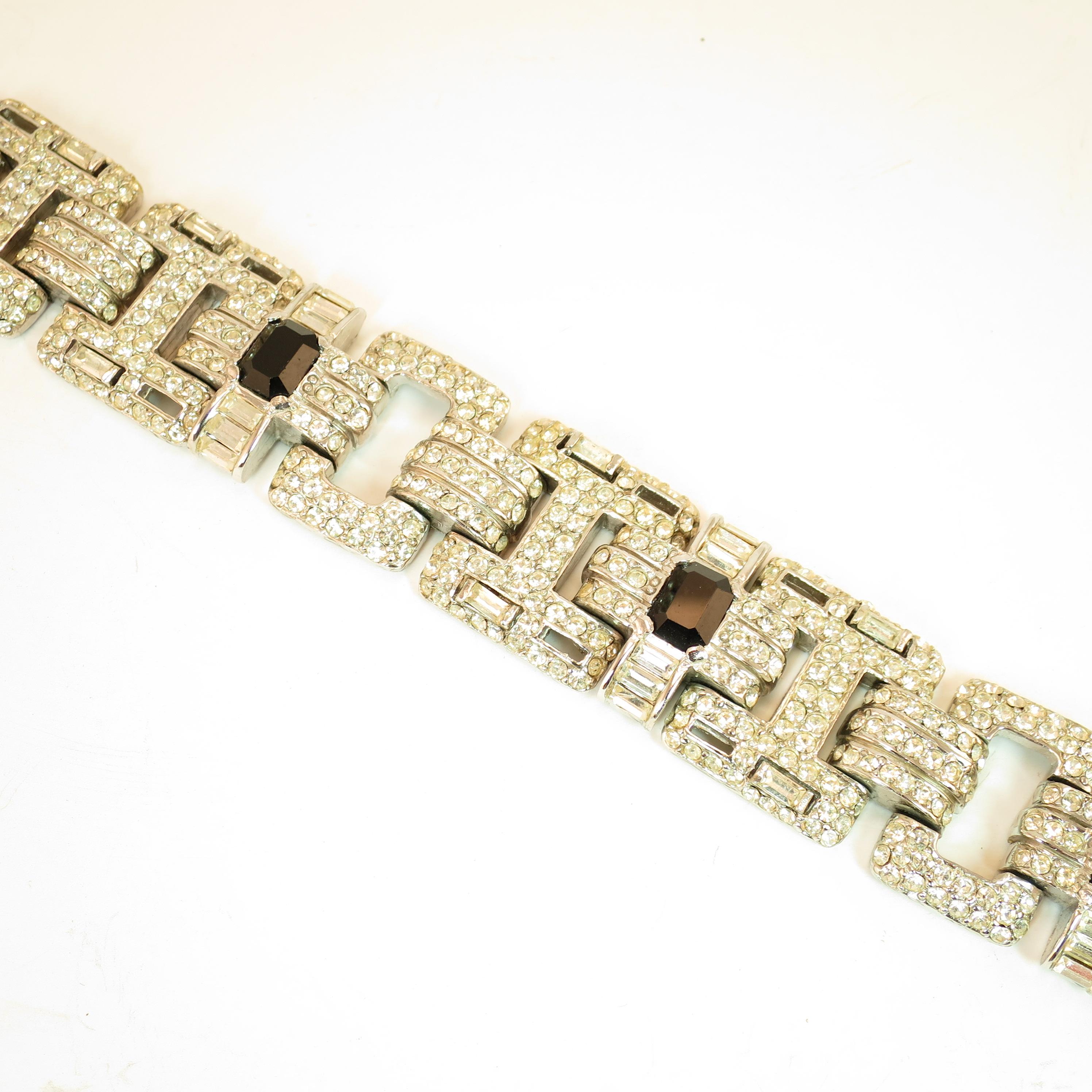 Offered here is a massive Ciner Art Deco-style heavy link bracelet in an open-work geometric design from the 1960s. The surface of the rhodium-plated links is wholly encrusted with pave-set round and baguette Swarovski crystals. Rectangular and