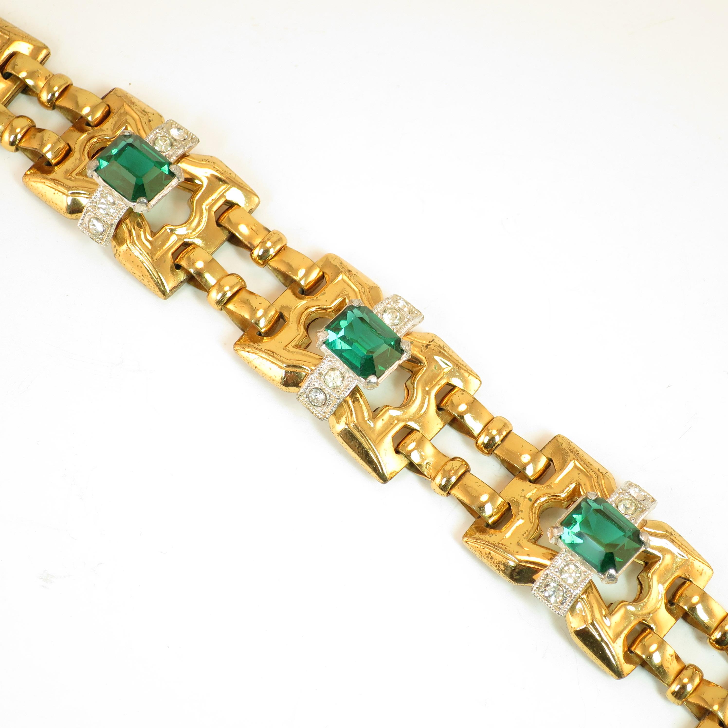 Offered here is a McClelland Barclay Art Deco gold-plated link bracelet from the 1930s. This classic Art Deco piece expresses his signature design of arched geometric platforms surmounted by silver-plated bands presenting rectangular emerald