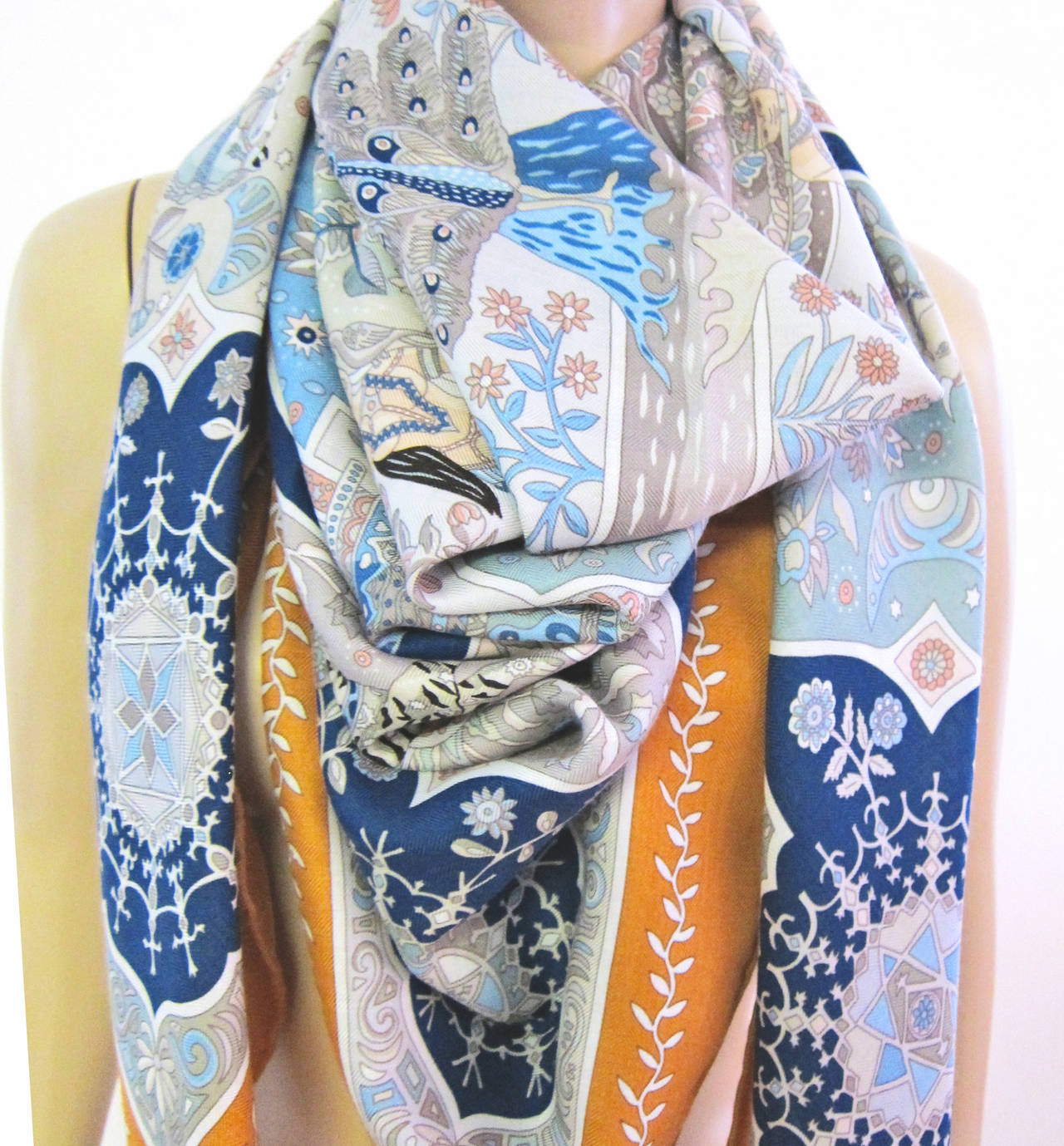 Hermes Aux Portes du Palais Ochre Cashmere Silk Shawl Scarf GM 140cm
Ethereal!
Colors:  Ochre, grey-green, blue, peachy pink, grey, dark blue…
Brand new in box.  Absolutely store fresh.  Never used with no issues or flaws.  
Comes brand new with