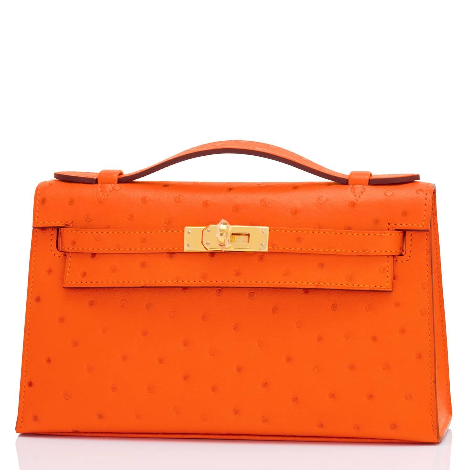 Hermes Tangerine Ostrich Mini Orange Kelly Pochette Gold Hardware
Brand New in Box. Store Fresh. Pristine Condition (with plastic on hardware).
Perfect gift! Comes with Hermes felt cover, orange box, sleeper, and ribbon.
Very rare and mesmerizing