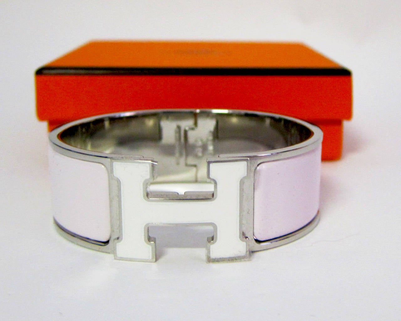 Hermes Rose Nymph White Lacquer Enamel H Clic Clac Bracelet Bangle

Brand new in box.  Absolutely store fresh!  
Size PM.  Model Wide.  Palladium plated hardware
2.25