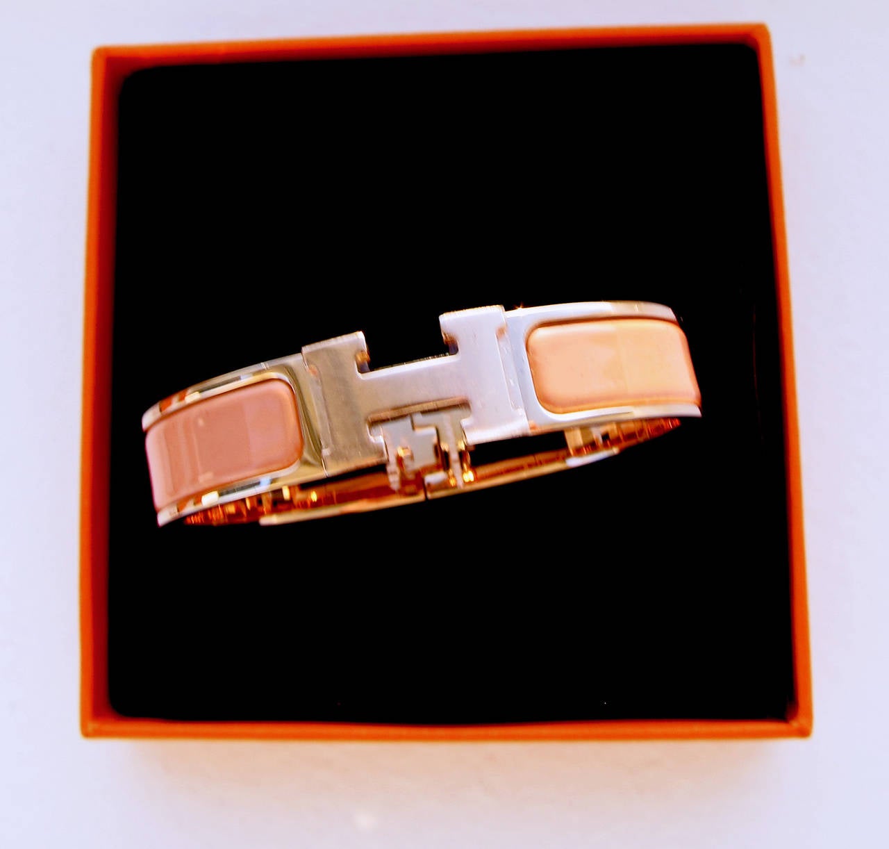 Hermes Salmon Clic H ROSE GOLD Hardware Enamel Romantic

Brand New in Box 
Store fresh with Hermes sleeper box and ribbon 
Narrow model. Size PM. 
ROSE GOLD plated hardware- SOLD OUT and impossible to find! 
2.5