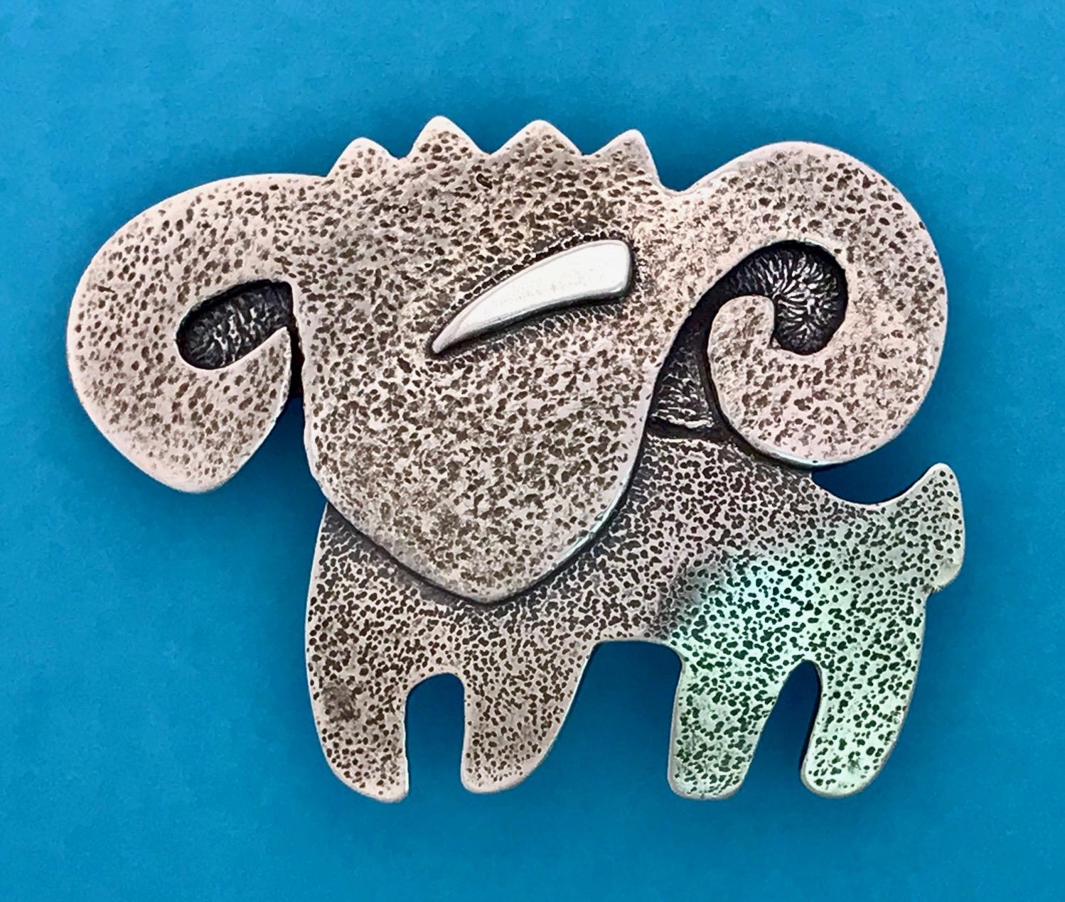 Patrick Joseph, Ram cast silver pendant Melanie Yazzie Navajo aries

Melanie A. Yazzie (Navajo-Diné) is a highly regarded multimedia artist known for her printmaking, paintings, sculpture, and jewelry designs.

She has exhibited, lectured, and