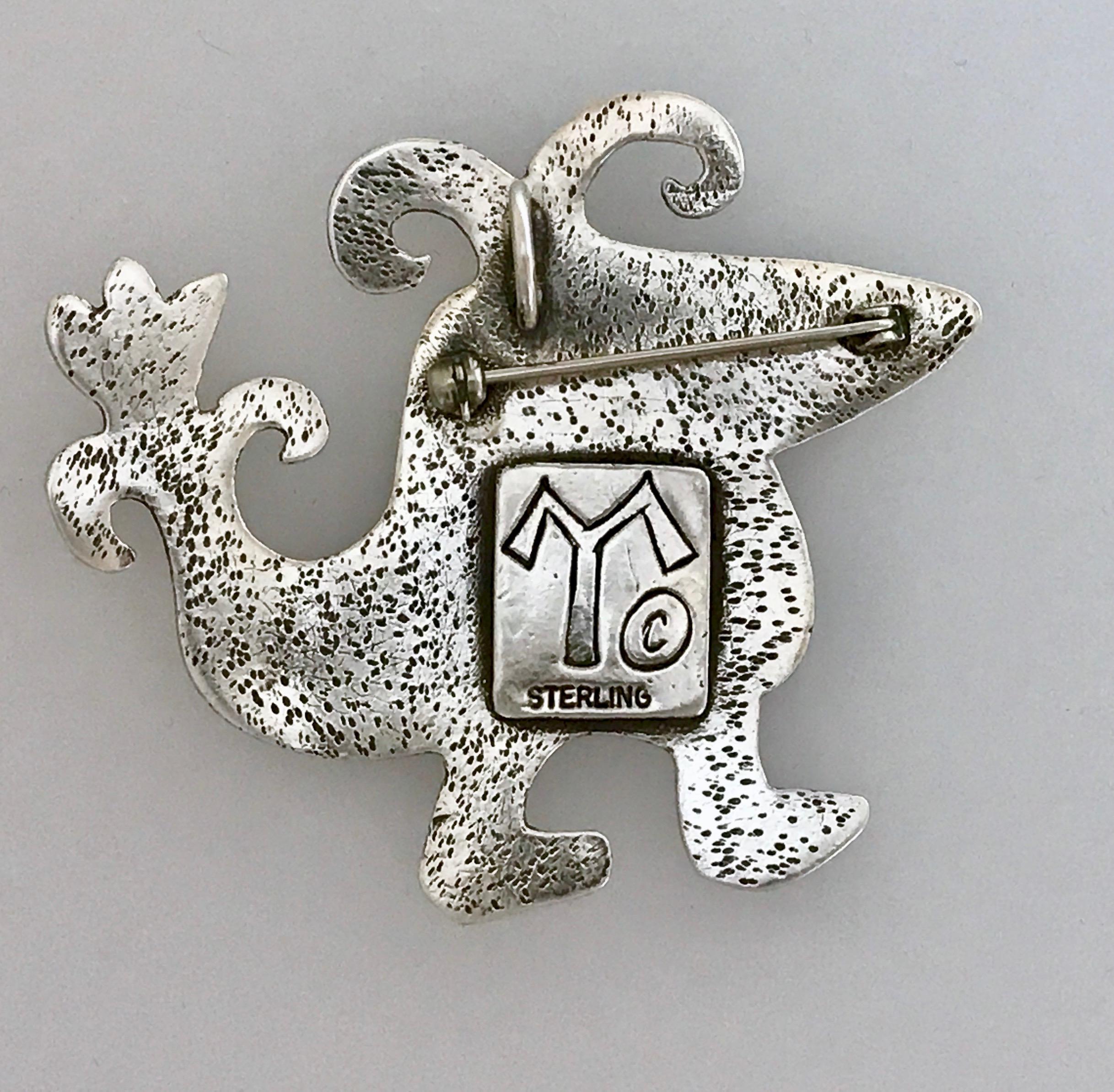 Little Jack, cast silver pin pendant bird dragonfly Melanie Yazzie 

Melanie A. Yazzie (Navajo-Diné) is a highly regarded multimedia artist known for her printmaking, paintings, sculpture, and jewelry designs.

She has exhibited, lectured, and