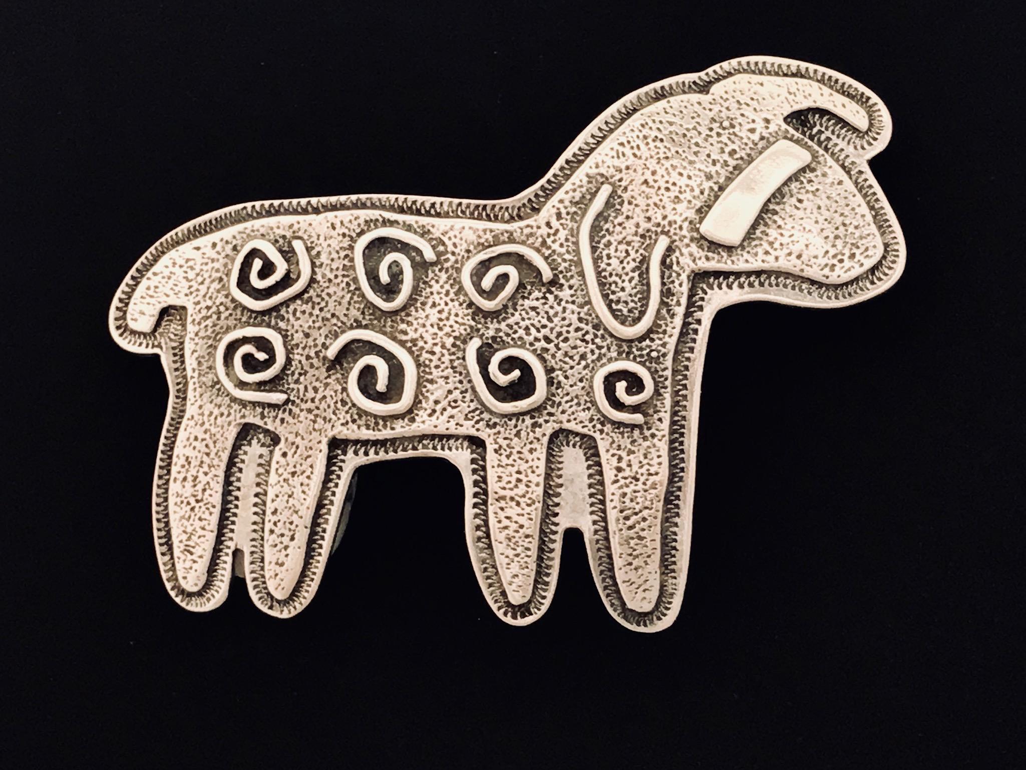 Curly Sheep, Sterling silver pin pendant Melanie Yazzie Navajo, Native American

Melanie A. Yazzie (Navajo-Diné) is a highly regarded multimedia artist known for her printmaking, paintings, sculpture, and jewelry designs.

She has exhibited,