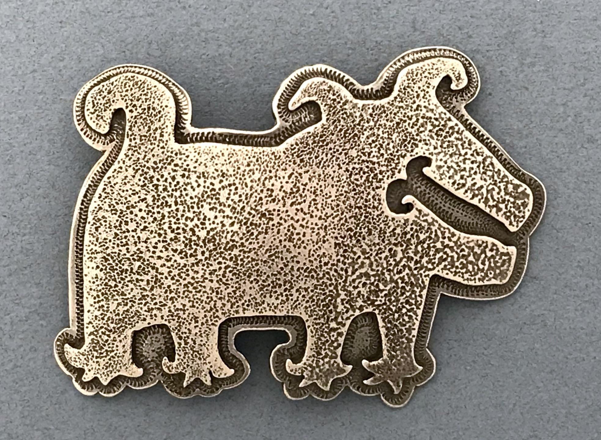 Dog with Funky Feet, sterling silver pin pendant Melanie Yazzie Navajo Native American new

Melanie A. Yazzie (Navajo-Diné) is a highly regarded multimedia artist known for her printmaking, paintings, sculpture, and jewelry designs.

She has
