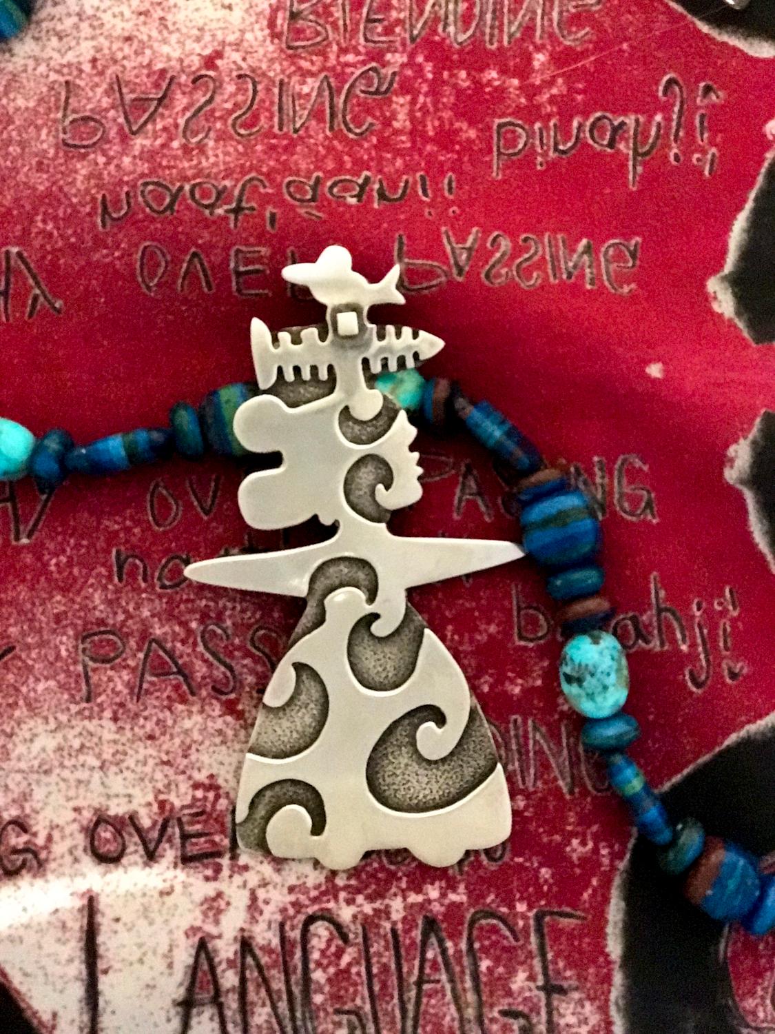 She Sings, pendant enhancer, Melanie Yazzie designs silver Navajo bird fish lady

Melanie A. Yazzie (Navajo-Diné) is a highly regarded multimedia artist known for her printmaking, paintings, sculpture, and jewelry designs.

She has exhibited,