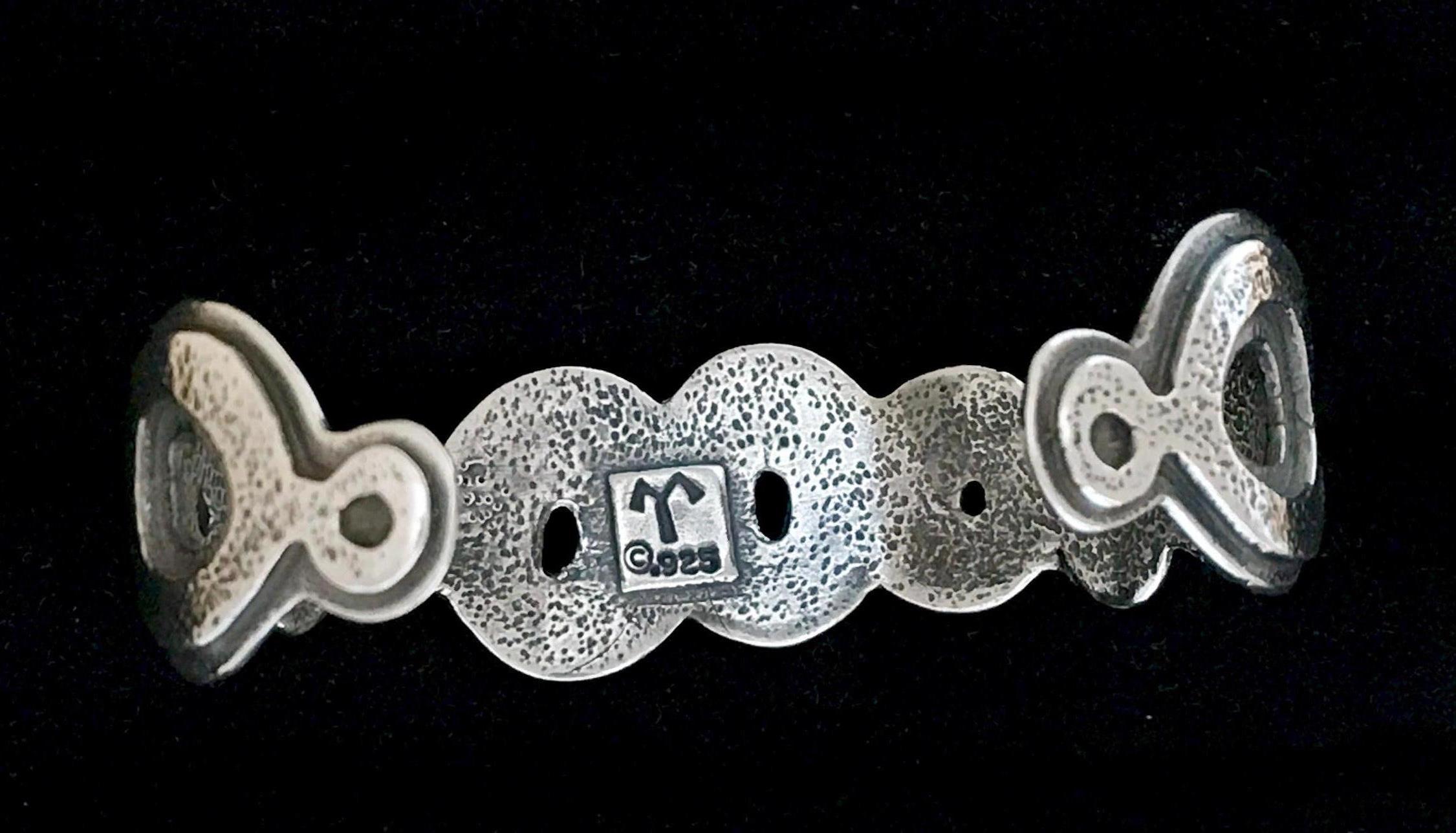 Spirit Pond, cast silver bracelet Melanie Yazzie Navajo water designs
Native American

Cast sterling silver bracelet. 5.5
