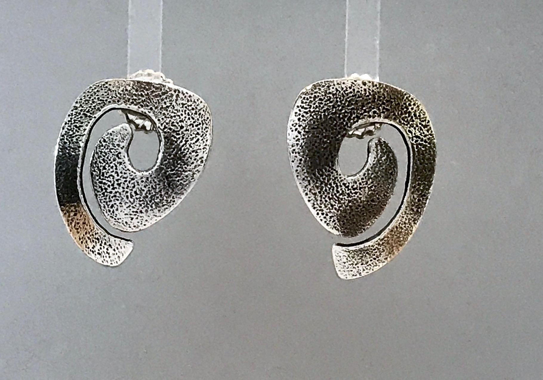 Swirls, silver post earrings Melanie Yazzie spiral Navajo contemporary new

Melanie A. Yazzie (Navajo-Diné) is a highly regarded multimedia artist known for her printmaking, paintings, sculpture, and jewelry designs.  

She has exhibited, lectured,