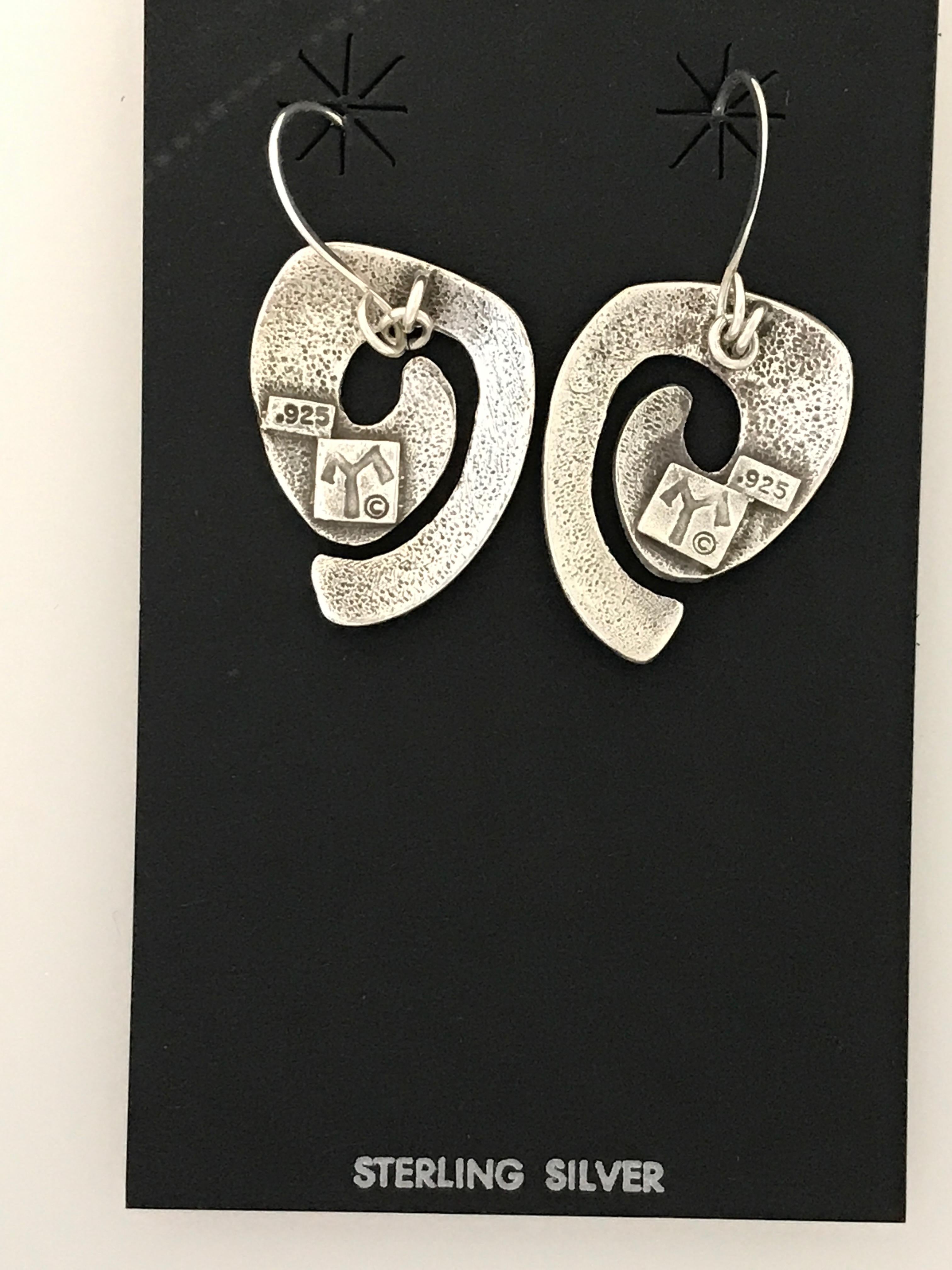 Swirls, dangle earrings, cast silver by Melanie Yazzie New Navajo contemporary

Melanie A. Yazzie (Navajo-Diné) is a highly regarded multimedia artist known for her printmaking, paintings, sculpture and jewelry designs.  

She has exhibited,