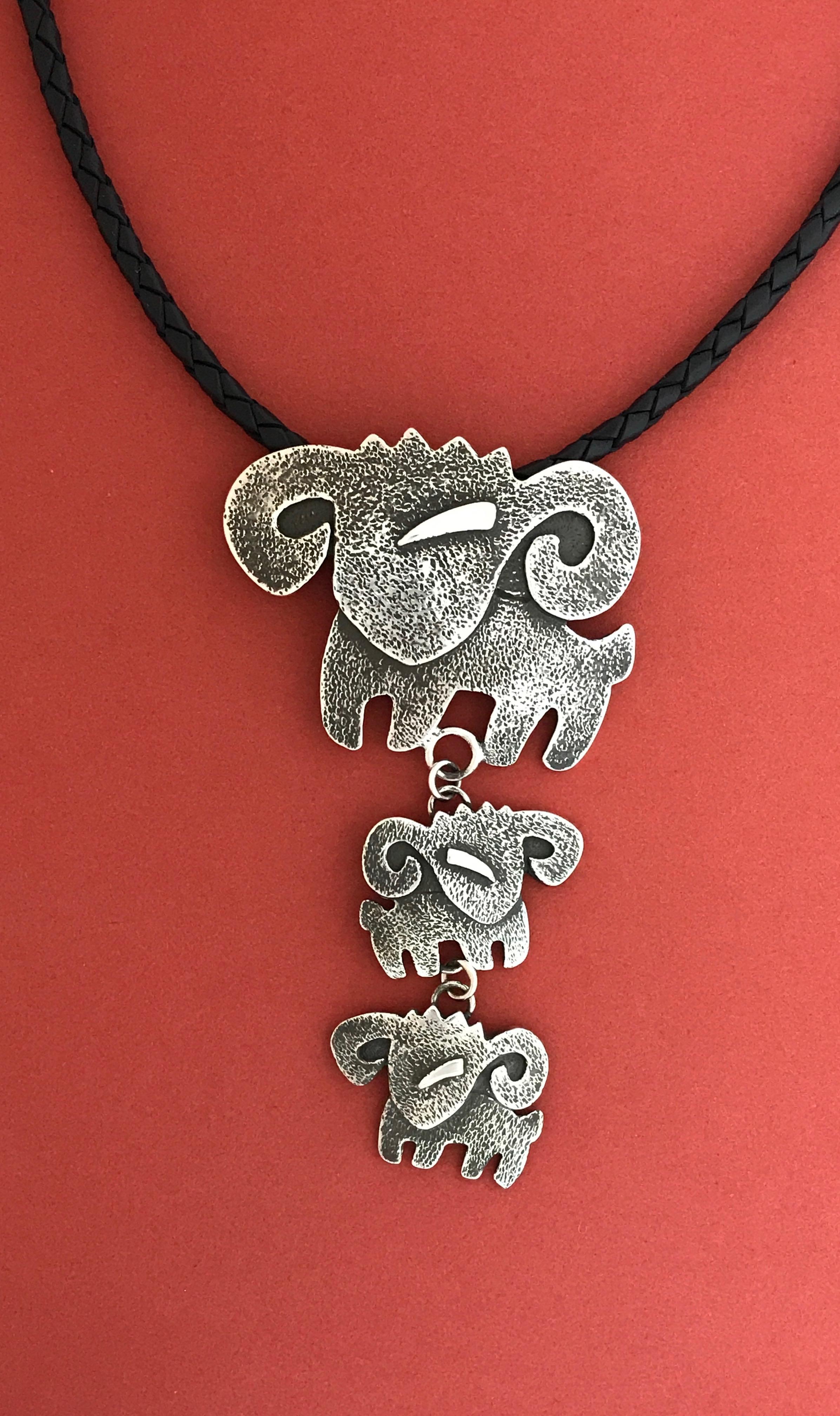Rams, cast sterling silver pendant Melanie Yazzie new Navajo necklace aries

Melanie A. Yazzie (Navajo-Diné) is a highly regarded multimedia artist known for her printmaking, paintings, sculpture, and jewelry designs.  She has exhibited, lectured,