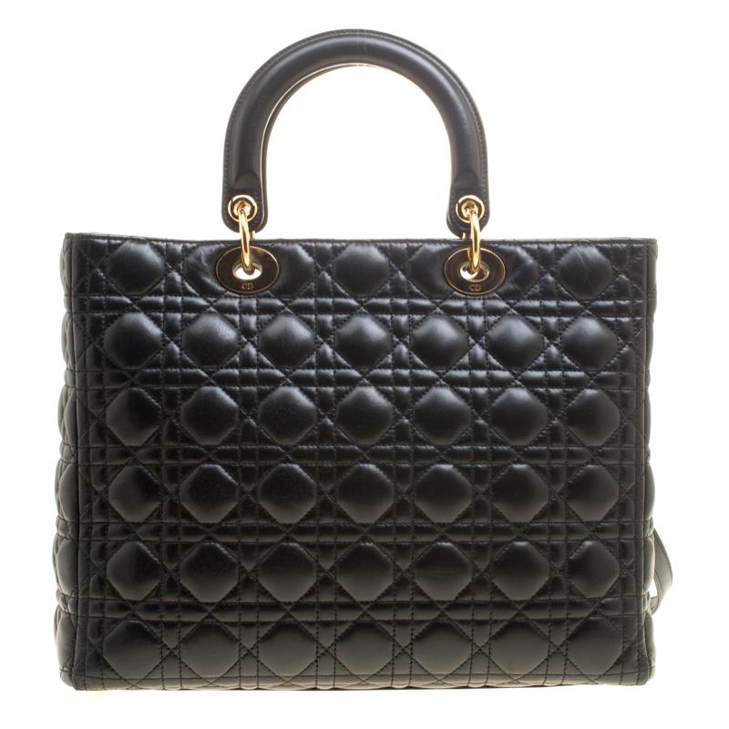 The Lady Dior tote is a Dior creation that was designed in 1994 and has gained lovers worldwide. Crafted from black leather this tote carries a cannage pattern exterior. It is equipped with dual rolled top handles, a shoulder strap, classic Dior