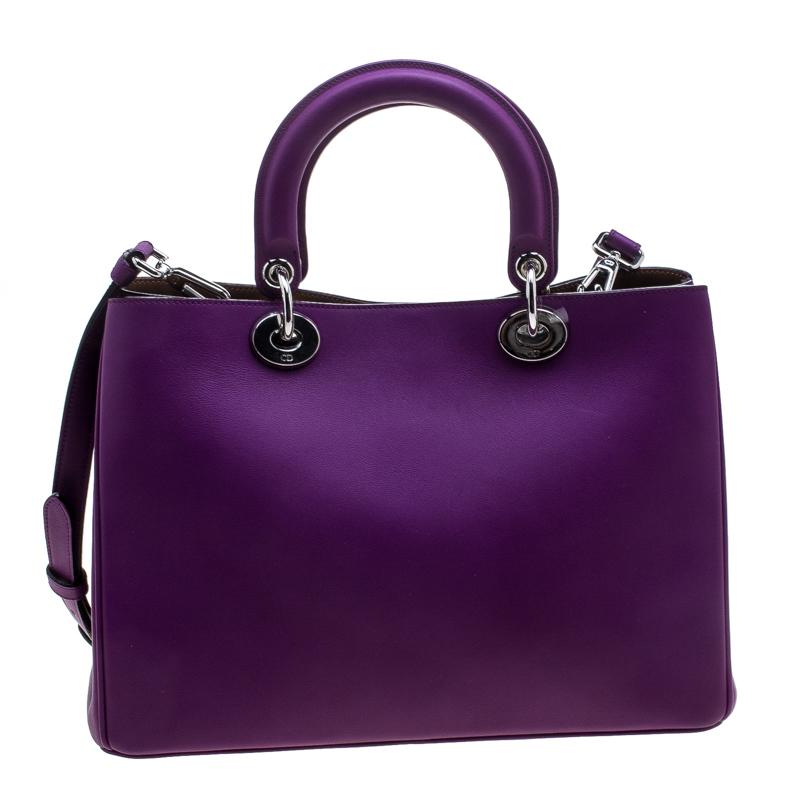 The Diorissimo bag from Dior is a piece that has never gone out of style. The leather bag comes in an enticing purple shade with silver-tone hardware and Dior letter charms. It features double top handles, a shoulder strap and protective feet at the