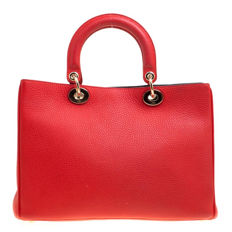 The Diorissimo bag from Dior is a piece that has never gone out of style. The leather bag comes in an enticing red shade with gold-tone hardware and Dior letter charms. It features double top handles, a small pouch and protective feet at the bottom.